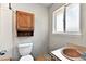 Modest bathroom with vintage vanity, neutral wall color, and matching medicine cabinet at 380 S Jersey St, Denver, CO 80224