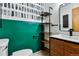 Stylish bathroom with modern vanity, open shelving, and trendy green accent wall at 380 S Jersey St, Denver, CO 80224