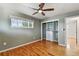 This bedroom features hardwood floors, closet with shelving and drawers, and a large window at 380 S Jersey St, Denver, CO 80224