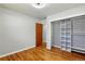 An empty bedroom features hardwood floors, light gray walls, and a closet with shelving at 380 S Jersey St, Denver, CO 80224