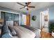 This bedroom features hardwood floors, gray walls, a large bed, and an ensuite bathroom at 380 S Jersey St, Denver, CO 80224