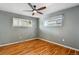This bedroom features hardwood floors, gray walls, a ceiling fan, and lots of natural light at 380 S Jersey St, Denver, CO 80224