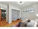 This bedroom features hardwood floors, closet with shelving, and a large window with natural light at 380 S Jersey St, Denver, CO 80224