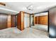 Bedroom featuring wood-paneled walls, mirrored closet, and plush carpeting at 380 S Jersey St, Denver, CO 80224