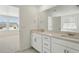 Spacious bathroom with double vanity, a large mirror and tile flooring at 7291 Prairie Sage Pl, Littleton, CO 80125