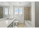 Bright bathroom featuring a vanity with a sink, toilet, and a bathtub with shower at 7291 Prairie Sage Pl, Littleton, CO 80125