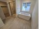 Modern bathroom featuring a soaking tub, glass-enclosed shower, and neutral color scheme at 7291 Prairie Sage Pl, Littleton, CO 80125