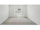 A clean, bright bedroom with neutral carpet, a window, and ample natural light at 7291 Prairie Sage Pl, Littleton, CO 80125
