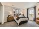 Cozy bedroom showcases a decorative accent wall, plush carpet, and window for natural light at 7291 Prairie Sage Pl, Littleton, CO 80125