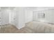 Bright bedroom featuring neutral carpet, crisp white walls, and a window for natural light at 7291 Prairie Sage Pl, Littleton, CO 80125