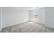 Neutral carpeted bedroom featuring a window with natural light at 7291 Prairie Sage Pl, Littleton, CO 80125