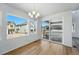 Bright dining area with sliding doors, large windows, and wood floors at 7291 Prairie Sage Pl, Littleton, CO 80125