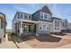 Charming two-story home featuring gray siding, white trim, a covered patio, and large windows offering ample natural light at 7291 Prairie Sage Pl, Littleton, CO 80125