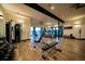 Spacious gym featuring modern fitness equipment and hardwood floors at 7291 Prairie Sage Pl, Littleton, CO 80125