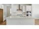 Modern kitchen showcasing a central island, stainless steel appliances, white subway tile backsplash, and sleek countertops at 7291 Prairie Sage Pl, Littleton, CO 80125