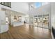 Sun-filled living room featuring tall ceilings, wood floors, modern fireplace, and sliding glass doors leading to an outdoor patio at 7291 Prairie Sage Pl, Littleton, CO 80125