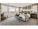 Serene main bedroom featuring large windows, a plush bed, and stylish decor at 7291 Prairie Sage Pl, Littleton, CO 80125