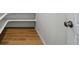 Walk-in pantry with built-in shelving and wood flooring at 7291 Prairie Sage Pl, Littleton, CO 80125