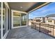 Covered patio featuring a metal railing, access to the home, and neighborhood views at 7291 Prairie Sage Pl, Littleton, CO 80125