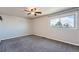 Spacious bedroom with a ceiling fan, a large window, and carpet at 15139 E Wesley Ave, Aurora, CO 80014