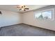 Neutral bedroom with a ceiling fan and a large window at 15139 E Wesley Ave, Aurora, CO 80014