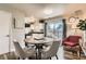 Dining area with modern furniture, opening to the kitchen and featuring a sliding door to the outside at 15139 E Wesley Ave, Aurora, CO 80014