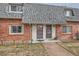 Brick townhome featuring a sidewalk leading to the front door at 15139 E Wesley Ave, Aurora, CO 80014