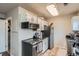 Efficient kitchen with stainless steel appliances and tile flooring at 15139 E Wesley Ave, Aurora, CO 80014