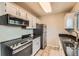 Functional kitchen equipped with sleek appliances, white cabinets and ample countertop space for cooking at 15139 E Wesley Ave, Aurora, CO 80014