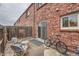 Patio with brick wall, sliding door, bike, and furniture set at 15139 E Wesley Ave, Aurora, CO 80014