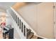 Hallway staircase with white banister and carpeted steps, leading to the upper level at 15139 E Wesley Ave, Aurora, CO 80014
