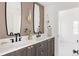 Chic bathroom with dark-stained vanity, dual sinks, marble countertop, and modern fixtures at 3932 Kalamath St, Denver, CO 80211