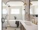 Luxurious bathroom features a soaking tub, glass shower, and double vanity with brass fixtures at 3932 Kalamath St, Denver, CO 80211