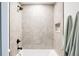 Bathroom featuring a fully tiled shower with a rainfall showerhead and black fixtures at 3932 Kalamath St, Denver, CO 80211