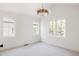 Bright bedroom with white walls, plush carpet, large windows, and a modern light fixture at 3932 Kalamath St, Denver, CO 80211