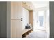 Entryway with light wood built-ins, a bench, storage cubbies, and light herringbone tile flooring at 3932 Kalamath St, Denver, CO 80211