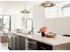 Kitchen island with marble countertop, stainless dishwasher, and pendant lighting fixtures at 3932 Kalamath St, Denver, CO 80211