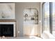 Living room with fireplace, built-in shelving, modern lighting, and access to the backyard at 3932 Kalamath St, Denver, CO 80211