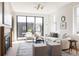 Bright living room featuring a fireplace, neutral furniture, and large sliding glass doors at 3932 Kalamath St, Denver, CO 80211