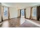 Bright dining area featuring tile floor, chandelier, large windows and sliding glass door access to the yard at 15786 Randolph Pl, Denver, CO 80239