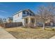 Two-story house with stone accents, a covered porch and an attached two-car garage at 15786 Randolph Pl, Denver, CO 80239