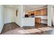 Efficient kitchen featuring wood cabinets, black appliances, and breakfast bar near the entry at 15786 Randolph Pl, Denver, CO 80239