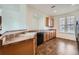 Bright kitchen features wood cabinets, brown tile floors, and black appliances, ideal for culinary enthusiasts at 15786 Randolph Pl, Denver, CO 80239