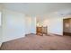 Spacious and neutral living room with a view of the stairs and a large window for natural light at 15786 Randolph Pl, Denver, CO 80239