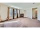 Spacious living room with neutral carpeting, a fireplace, and windows with elegant curtains at 15786 Randolph Pl, Denver, CO 80239