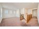 Bright living room with large windows for natural light and neutral colored carpet on the floor at 15786 Randolph Pl, Denver, CO 80239