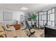 Comfortable basement area with workout equipment including a bench and shoe rack at 2092 S Helena St # C, Aurora, CO 80013