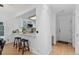 Bright kitchen featuring an open bar with two stools, granite countertops and white cabinetry at 2092 S Helena St # C, Aurora, CO 80013