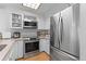 Bright kitchen featuring stainless steel appliances and warm ceiling lighting at 2092 S Helena St # C, Aurora, CO 80013