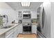 Bright kitchen featuring stainless steel appliances, including microwave and oven at 2092 S Helena St # C, Aurora, CO 80013